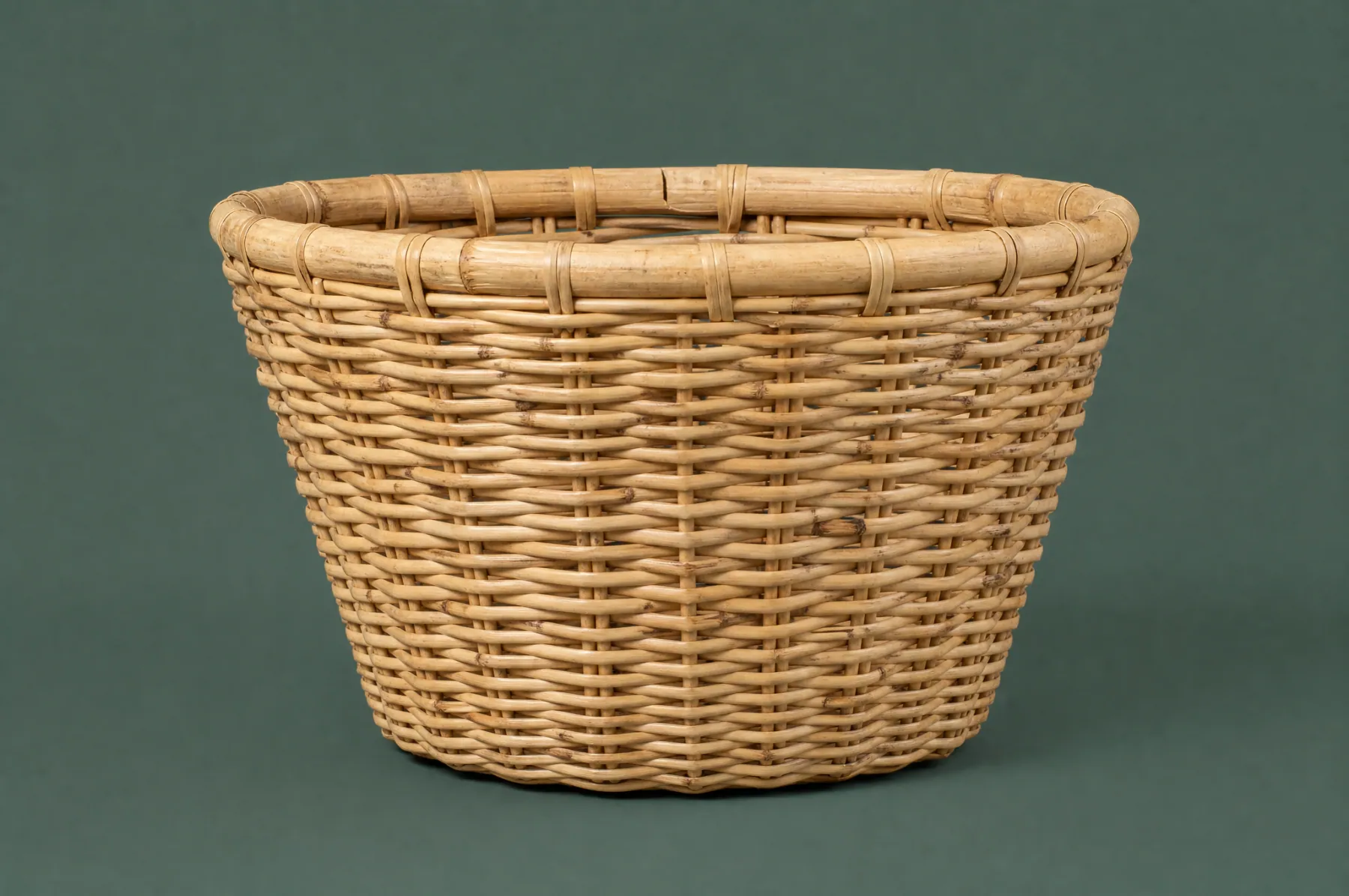 ON-A-01, a hand-woven rattan basket, photographed straight on. This is the piece you would receive.