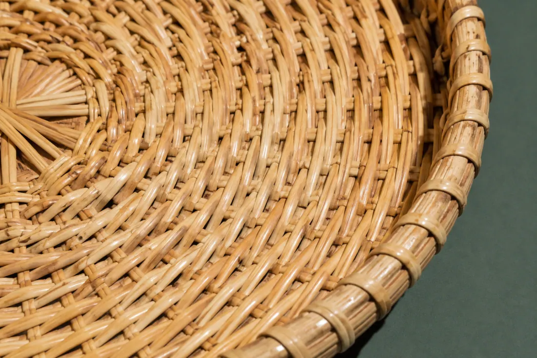 The weave and rim of ON-A-02 in close-up. Weave starts at the base centre and runs clockwise; the closing stake sits directly opposite the deepest rim dip.
