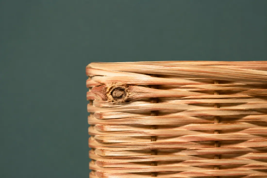 The visible flaw on ON-A-03: A knot in the cane makes a 4 mm bump on the outer wall at roughly ten o’clock. The rim binding is doubled over a 50 mm stretch where the first wrap ran short.