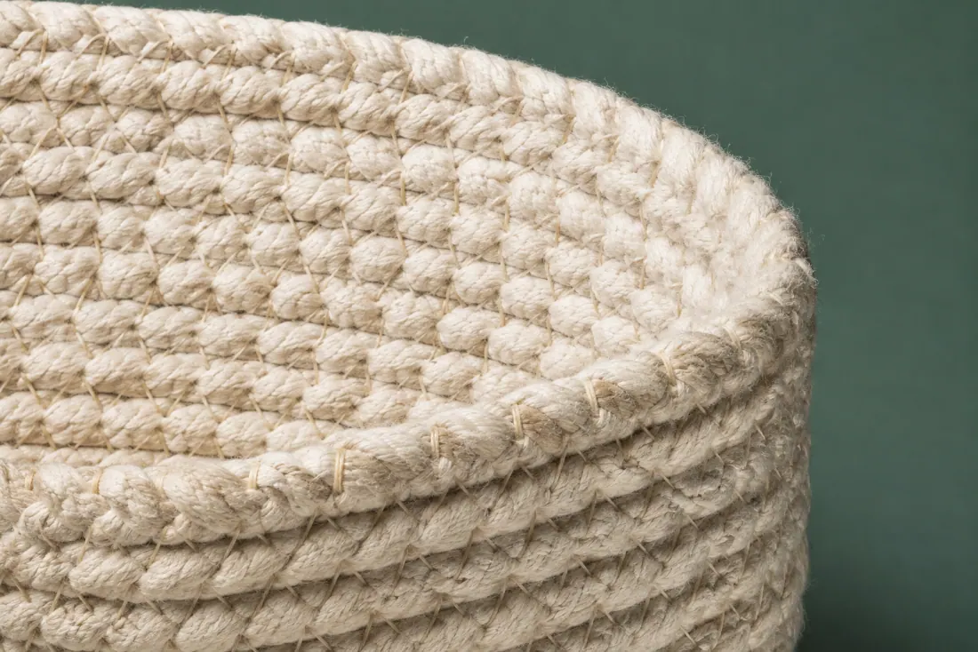 The weave and rim of ON-A-12 in close-up. Coiled from a flat oval start; the direction of stitch reverses once at 120 mm to keep the wall upright.