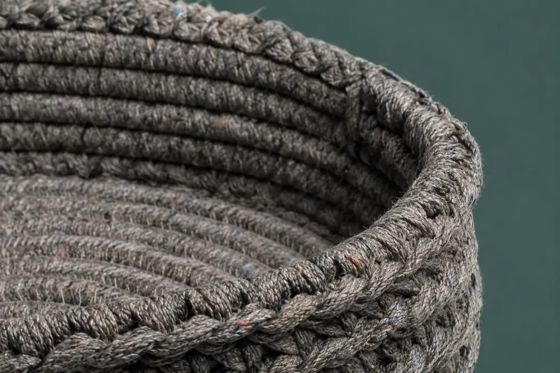 The weave and rim of ON-A-14 in close-up. Coiled from the base centre outward; the tail is sewn down over the last 60 mm of rim.