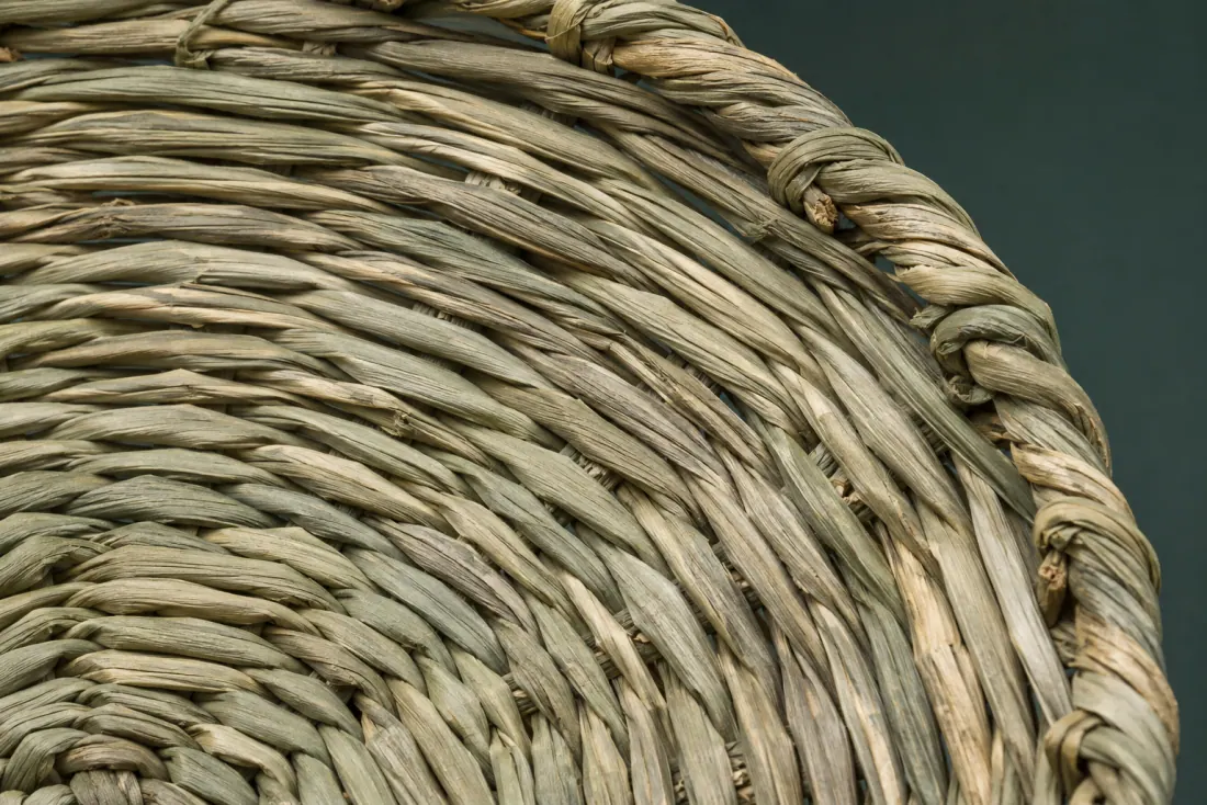 The weave and rim of ON-B-05 in close-up. Twisted rush coiled from the centre; the finish runs out over the final 50 mm of rim.