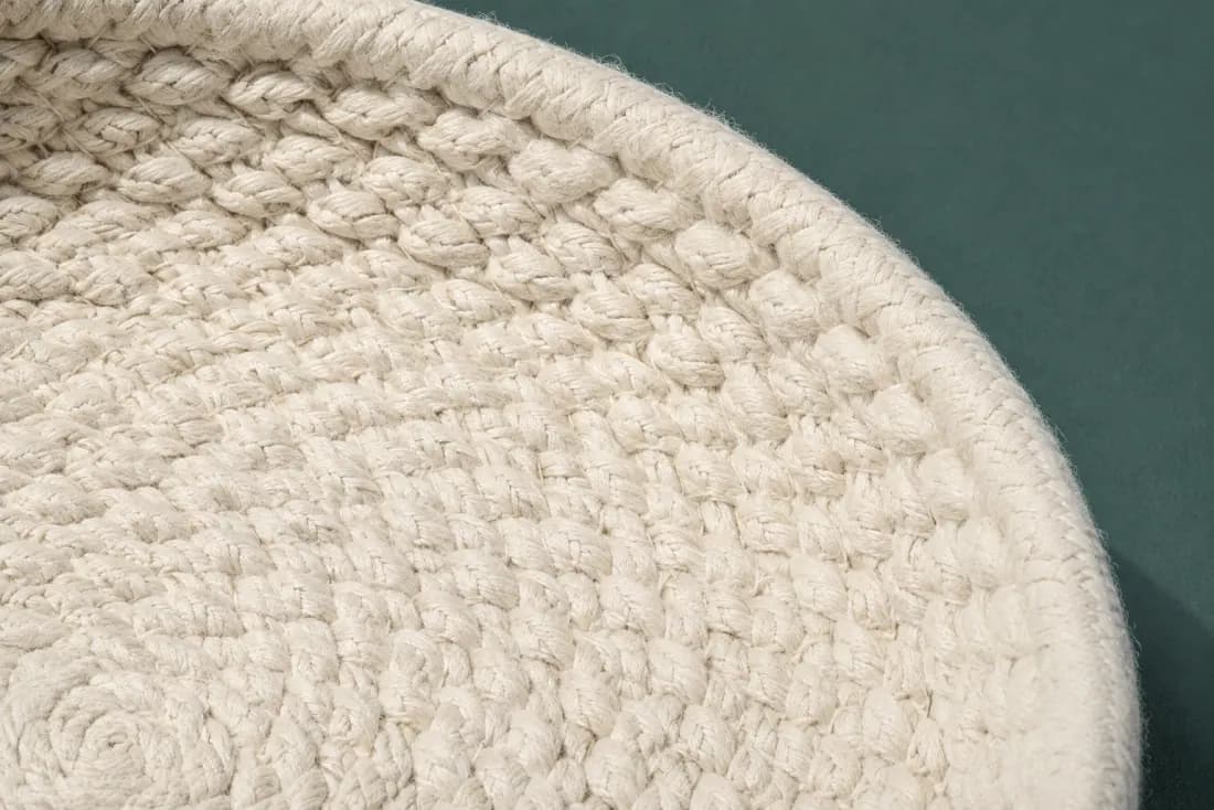 The weave and rim of ON-B-08 in close-up. Flat coil from the centre; the rim turn happens over the last two rounds and the tail is buried at the back.