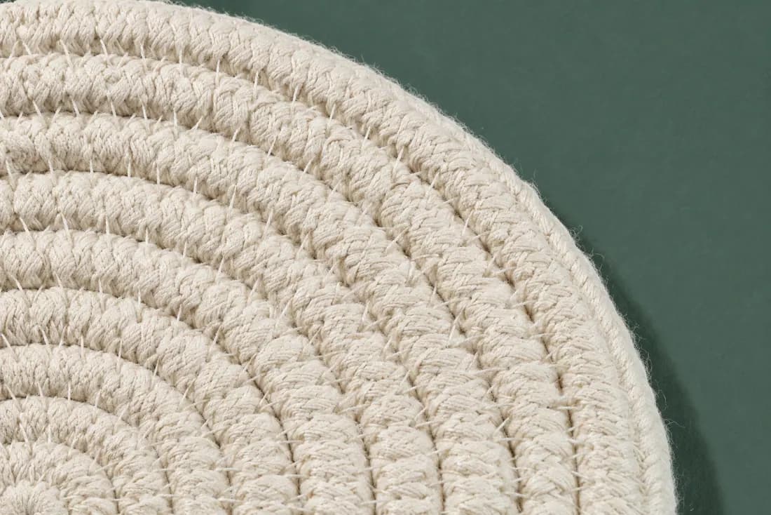 The weave and rim of ON-B-09 in close-up. Coiled from a tight centre disc; the wall lifts from round four and the tail is trimmed at the front.