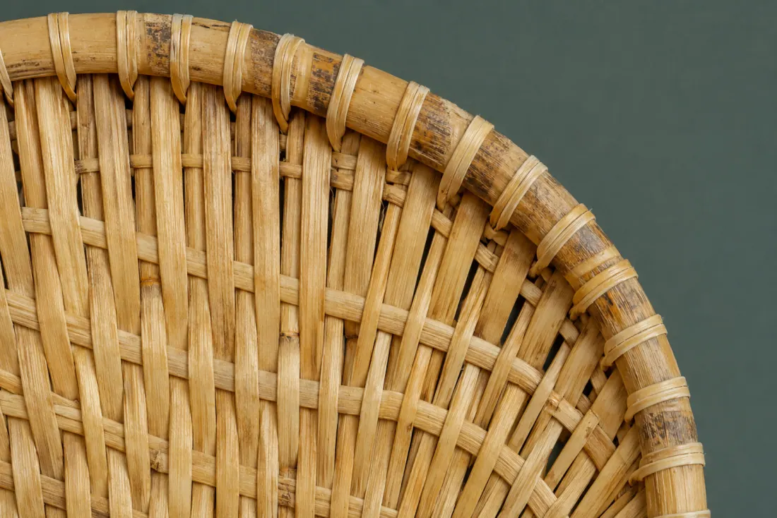 The weave and rim of ON-D-03 in close-up. Radial strips over a hoop; the field pattern reverses at the halfway radius.