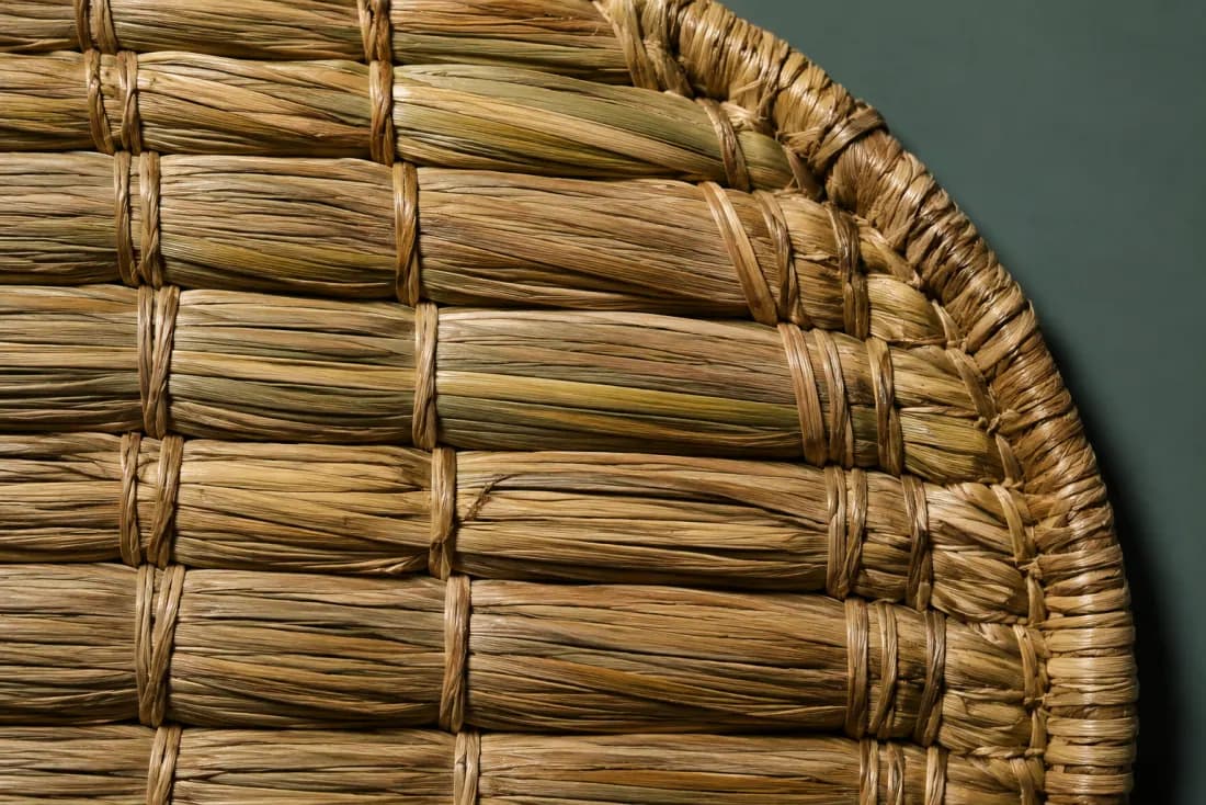 The weave and rim of ON-D-04 in close-up. Coils run the long axis and are stitched to each other; the last coil finishes at the lower right corner.
