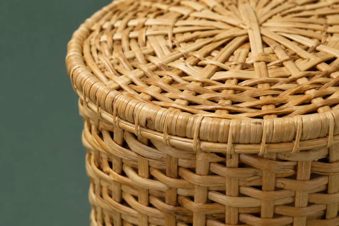 The weave and rim of ON-E-02 in close-up. Body woven up from a six-point base in the opposite hand to its pair; the lid closes at the back.