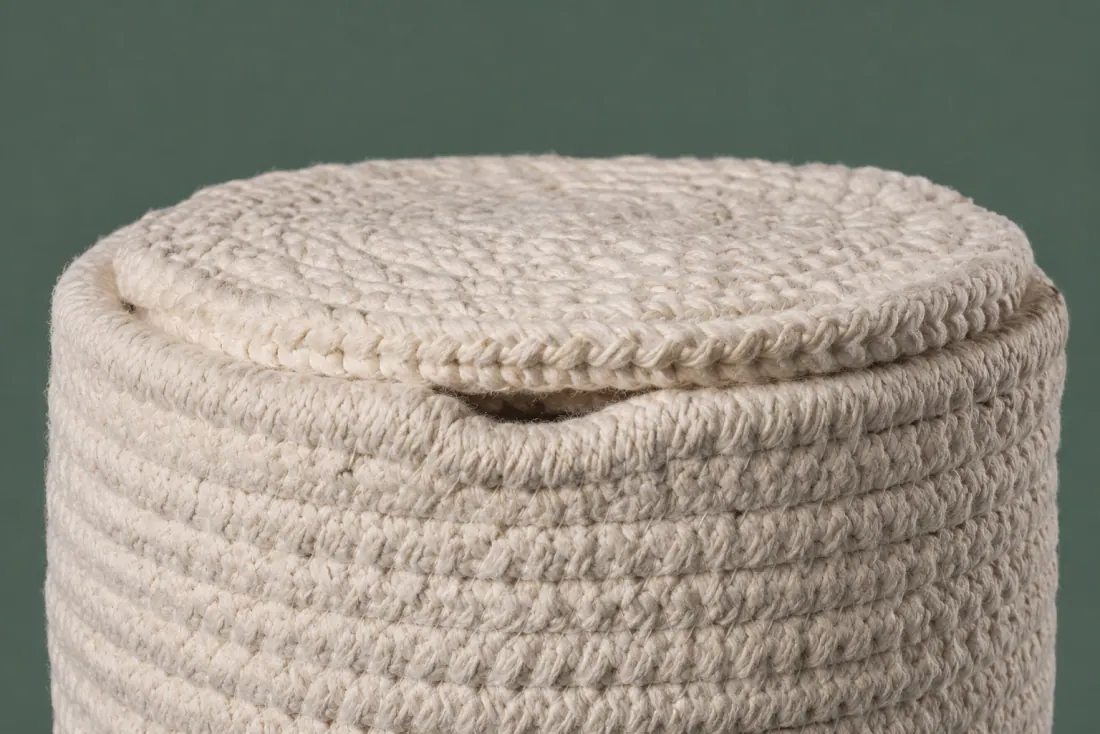 The visible flaw on ON-E-08: The lid drops 2 mm inside the body rim on one side rather than sitting on it. One stitch loop stands proud on the lid centre.