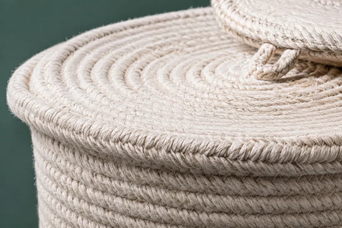 The weave and rim of ON-E-09 in close-up. Coiled from a flat base with the stitch direction reversing once at 240 mm; the lid is a separate flat coil.