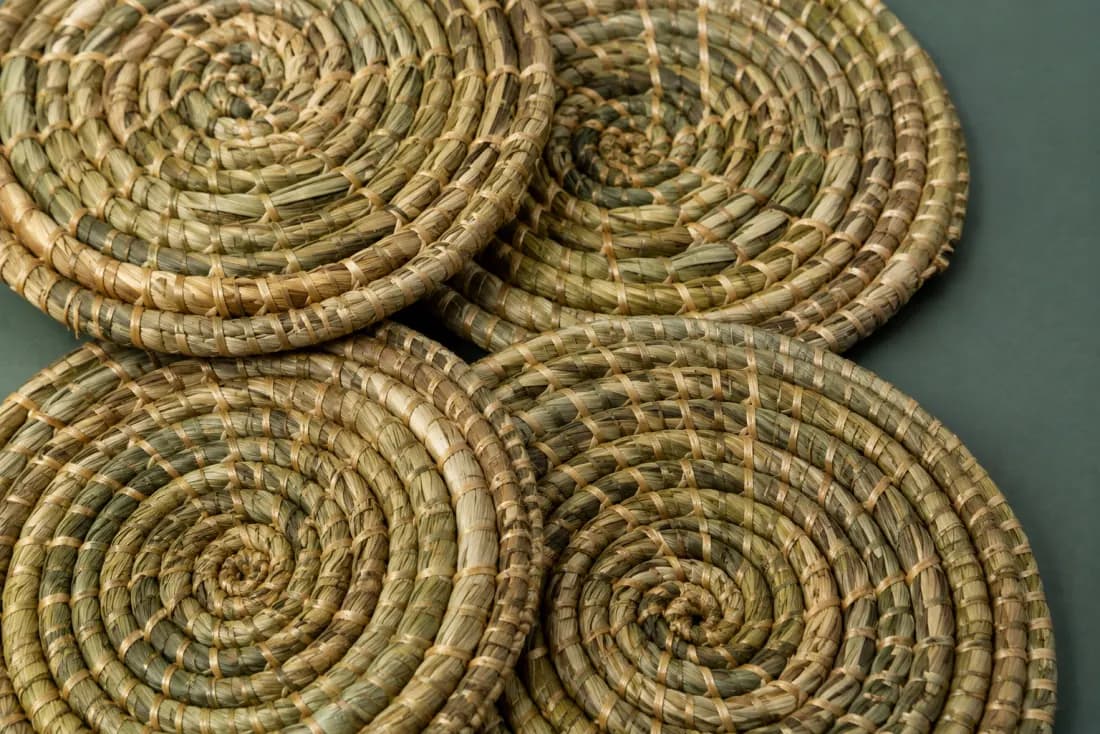 The weave and rim of ON-F-02 in close-up. Coiled from the centre in the opposite hand to its pair; tails are bound off on the underside.