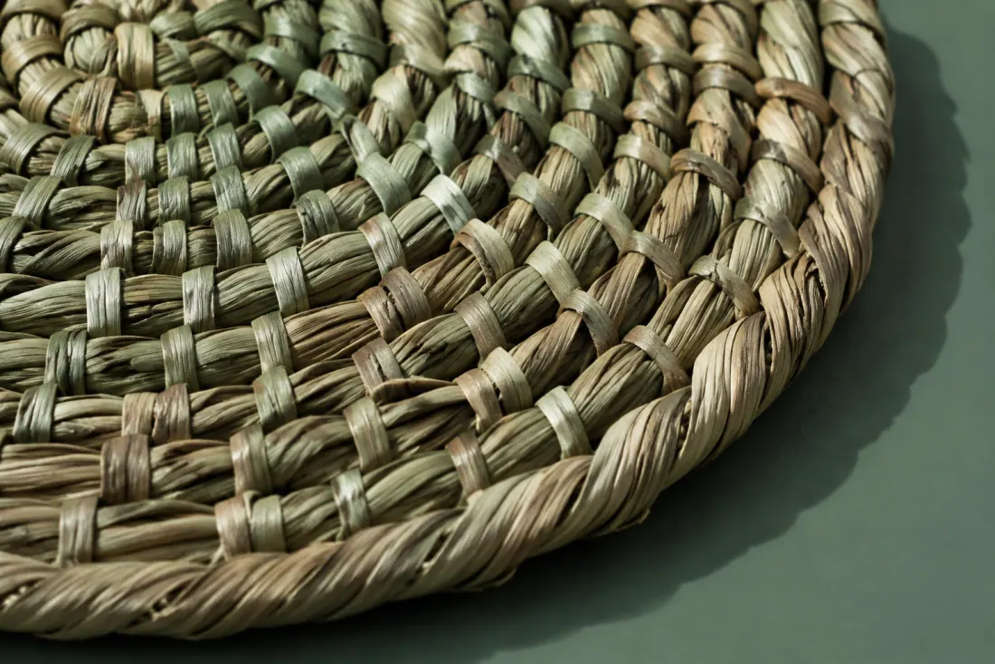 The weave and rim of ON-F-04 in close-up. Coiled from the centre in the opposite hand to its pair; the tail is cut square.