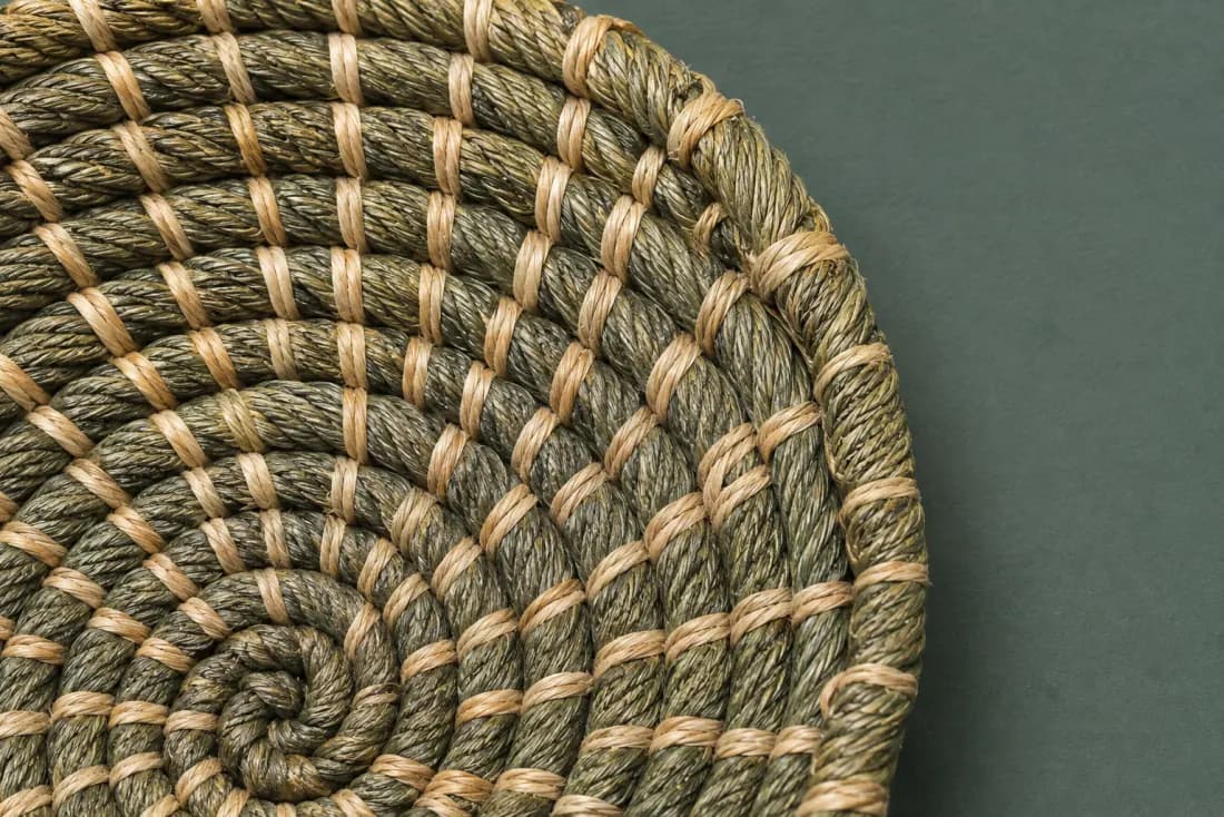 The weave and rim of ON-F-06 in close-up. Coiled from a tight centre; the wall lifts from the third round and the tail is bound at the front.