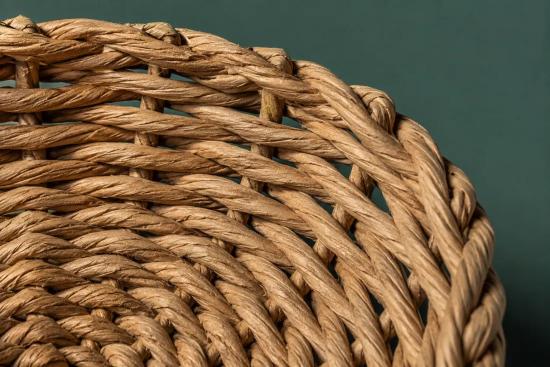 The weave and rim of ON-F-11 in close-up. Twined over short radial stakes; the weave closes at the front and stake ends fold under the rim.