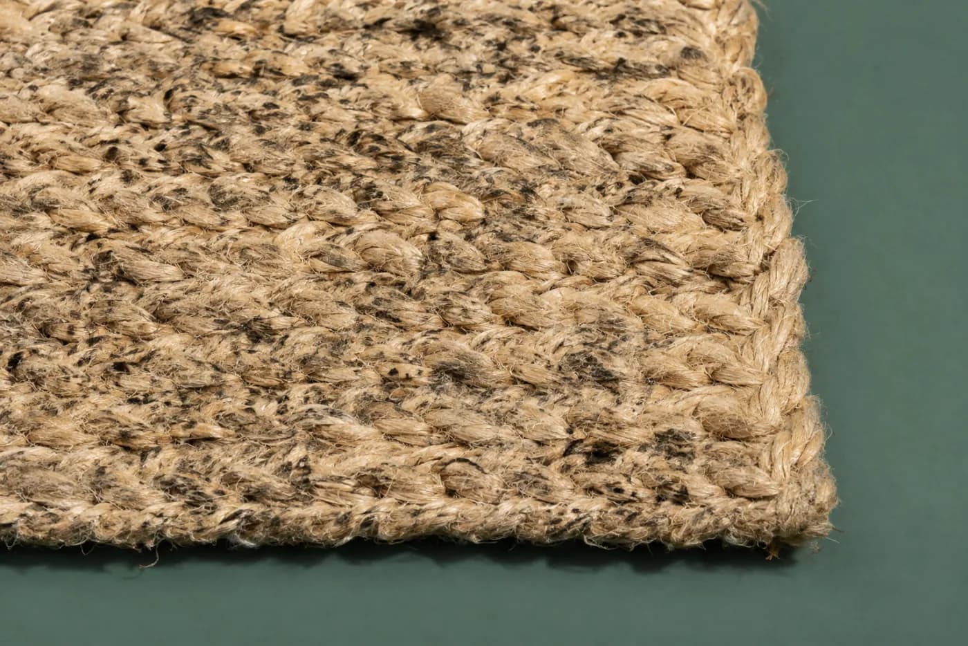 Dark mould spotting on the surface of a natural woven fibre kept in damp conditions.